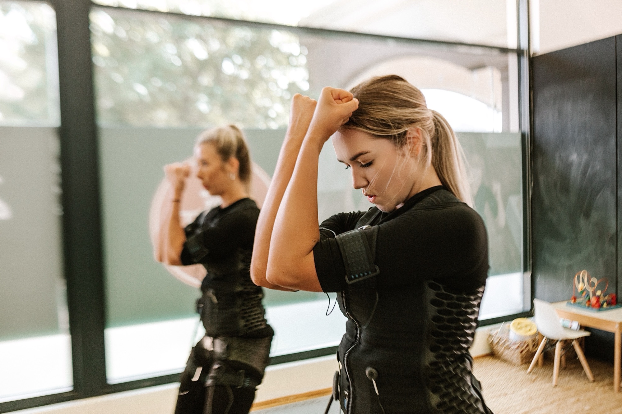 Two women training with arms raised