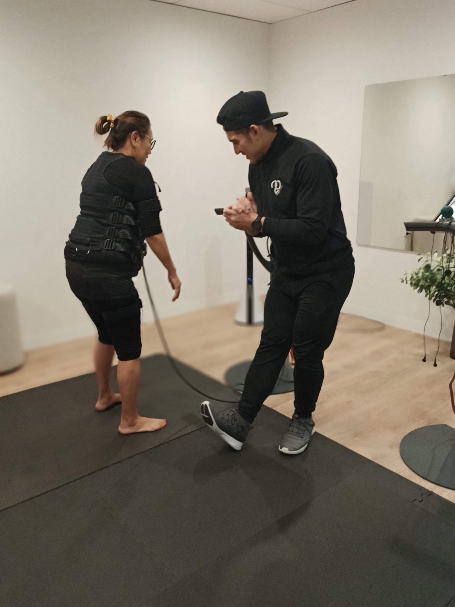 Client boxing with trainer holding the pad